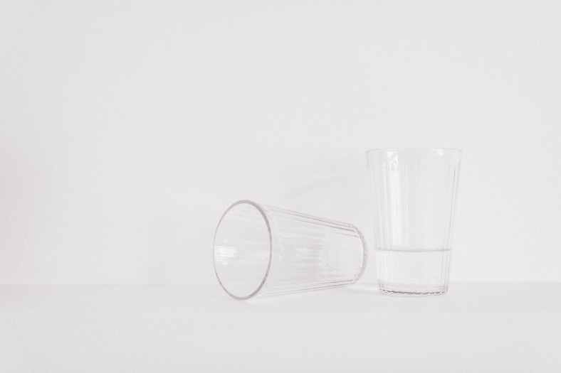 two clear drinking glasses on table